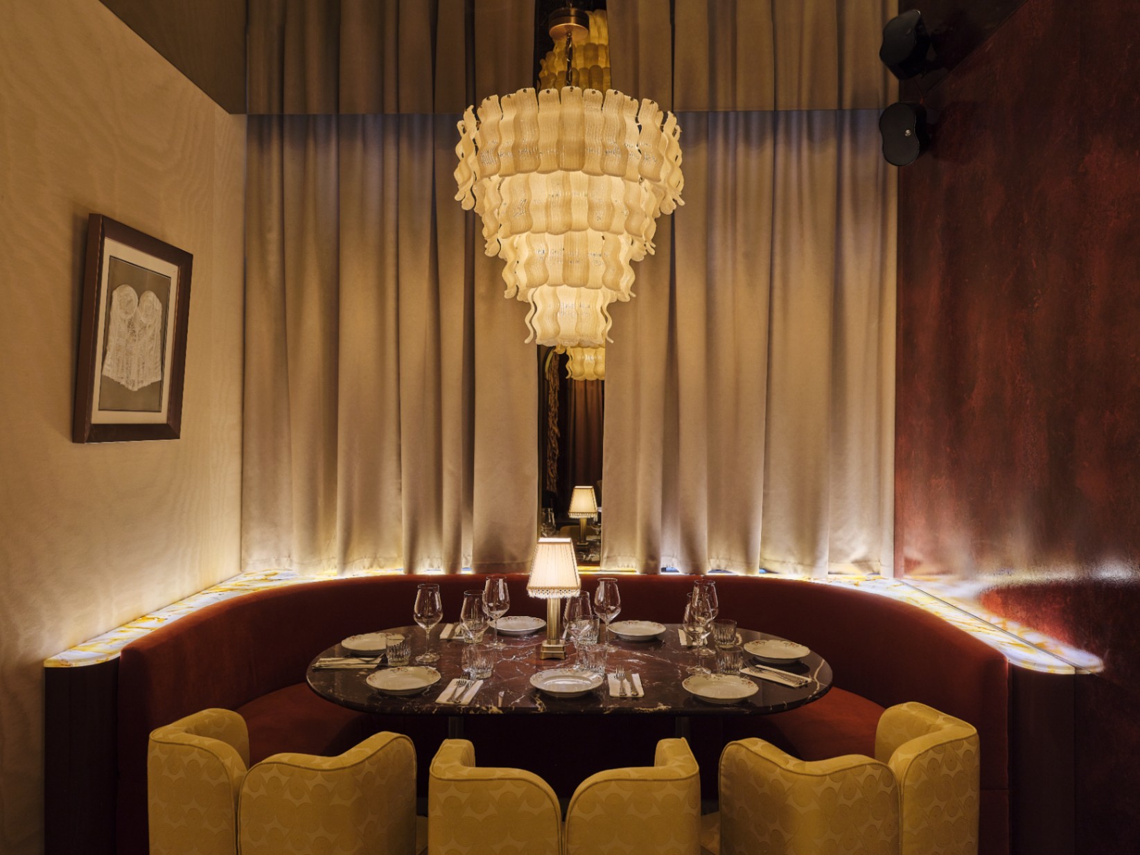 Private dining room with chandelier and velvet seating